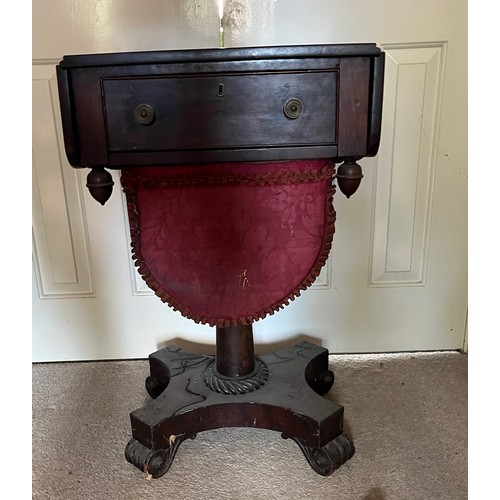 22 - A drop leaf mahogany sewing table raised on a single column base, and with a faux drawer to the rear... 