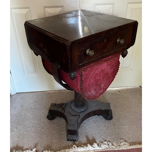 22 - A drop leaf mahogany sewing table raised on a single column base, and with a faux drawer to the rear... 