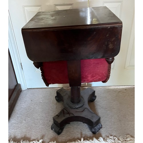 22 - A drop leaf mahogany sewing table raised on a single column base, and with a faux drawer to the rear... 