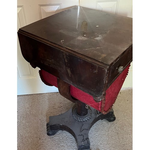 22 - A drop leaf mahogany sewing table raised on a single column base, and with a faux drawer to the rear... 