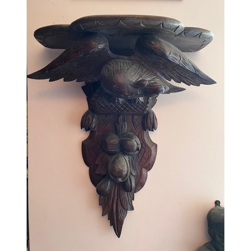 27 - A Black Forest hand carved wall bracket with a carved eagle support, 53 cm wide x 63 cm high x 23 cm... 