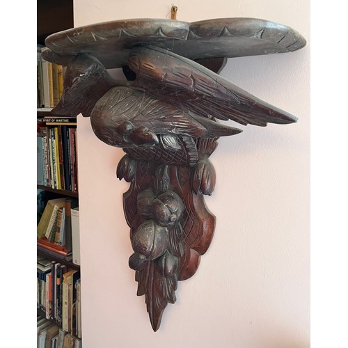 27 - A Black Forest hand carved wall bracket with a carved eagle support, 53 cm wide x 63 cm high x 23 cm... 