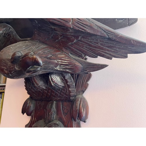 27 - A Black Forest hand carved wall bracket with a carved eagle support, 53 cm wide x 63 cm high x 23 cm... 