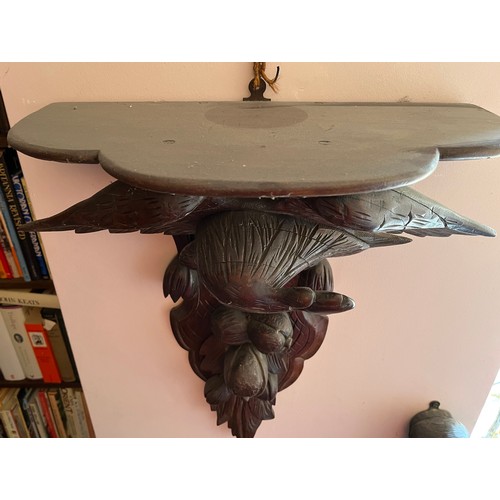 27 - A Black Forest hand carved wall bracket with a carved eagle support, 53 cm wide x 63 cm high x 23 cm... 