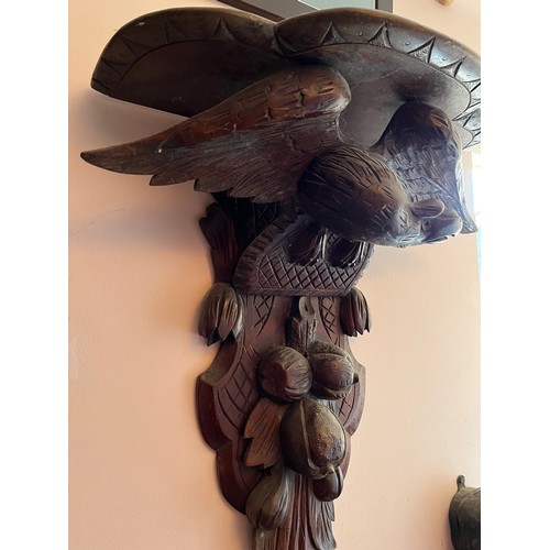 27 - A Black Forest hand carved wall bracket with a carved eagle support, 53 cm wide x 63 cm high x 23 cm... 