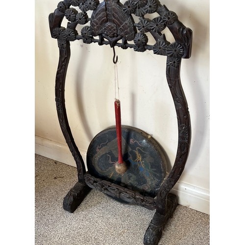 33 - Floor standing gong decorated with a dragon on a carved support.

This lot is collection only