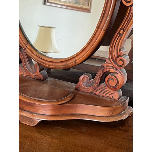 44 - A Victorian dressing table mirror, an oval framed mirror on carved supports, 73 cm high x 55 cm wide... 