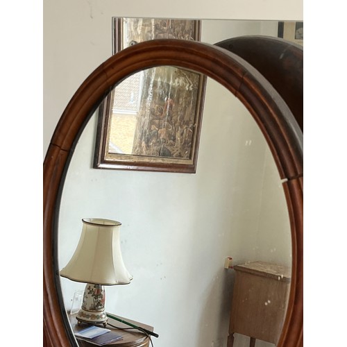 44 - A Victorian dressing table mirror, an oval framed mirror on carved supports, 73 cm high x 55 cm wide... 