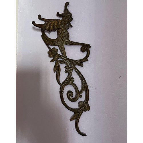 46 - Two cast brass decorative sections featuring winged creatures, each is 30 cm  x 14 cm.

This lot is ... 