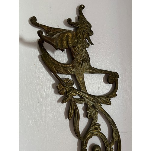 46 - Two cast brass decorative sections featuring winged creatures, each is 30 cm  x 14 cm.

This lot is ... 