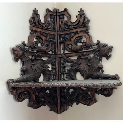 64 - Black forest hand carved corner shelf with winged mythical creatures.

This lot is collection only