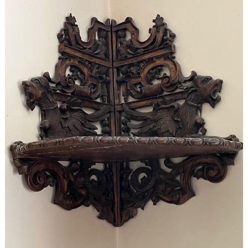 64 - Black forest hand carved corner shelf with winged mythical creatures.

This lot is collection only