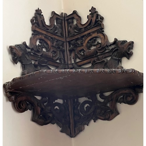 64 - Black forest hand carved corner shelf with winged mythical creatures.

This lot is collection only