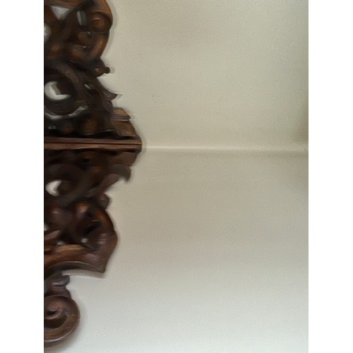 64 - Black forest hand carved corner shelf with winged mythical creatures.

This lot is collection only