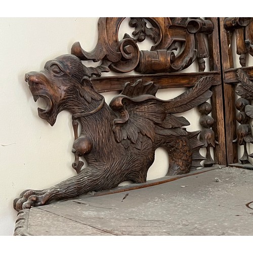 64 - Black forest hand carved corner shelf with winged mythical creatures.

This lot is collection only