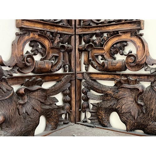 64 - Black forest hand carved corner shelf with winged mythical creatures.

This lot is collection only