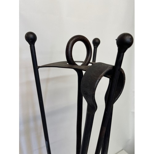 68 - A large modern blacksmith made wrought iron fireside companion set on stand.

This lot is available ... 