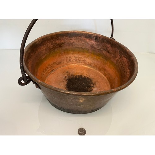 70 - Large copper cooking pan with a wrought iron hanging handle 40 cm dia x 17 cm high.

This lot is ava... 