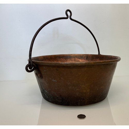 70 - Large copper cooking pan with a wrought iron hanging handle 40 cm dia x 17 cm high.

This lot is ava... 