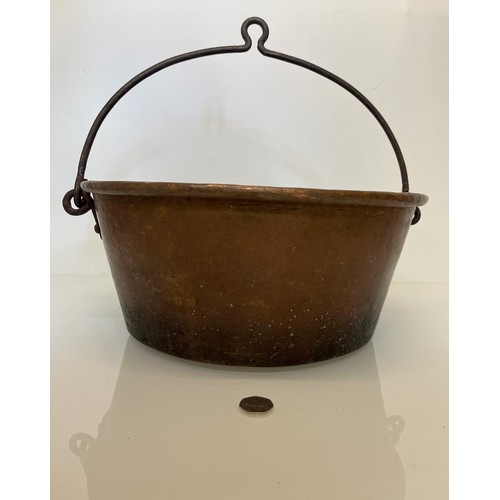 70 - Large copper cooking pan with a wrought iron hanging handle 40 cm dia x 17 cm high.

This lot is ava... 