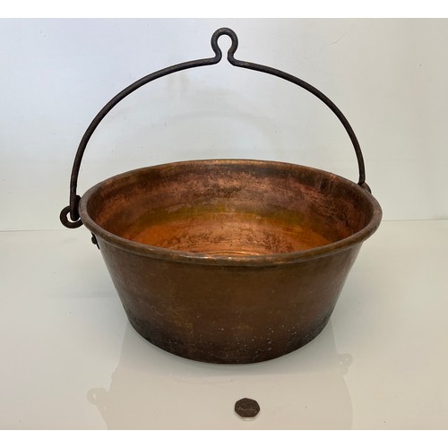 70 - Large copper cooking pan with a wrought iron hanging handle 40 cm dia x 17 cm high.

This lot is ava... 