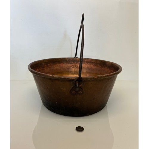 70 - Large copper cooking pan with a wrought iron hanging handle 40 cm dia x 17 cm high.

This lot is ava... 