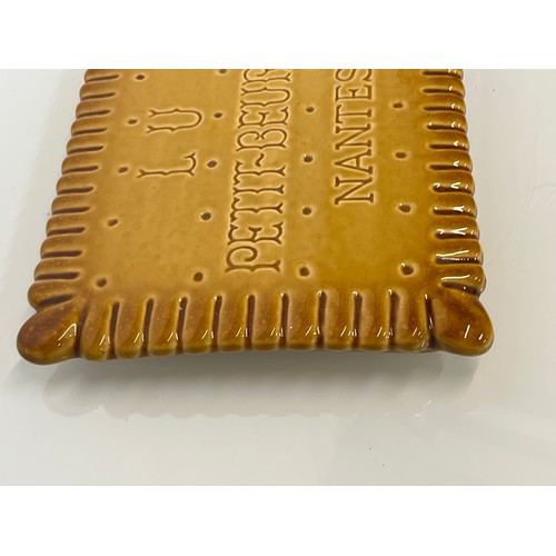 75 - Ceramic advertising French biscuit shaped promotional platter 25 cm x 20 cm.

This lot is available ... 