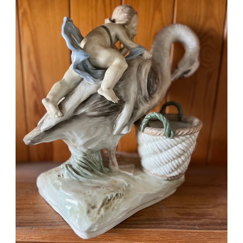 389 - Classical ceramic figure of a child on the back of a swan.

This lot is available for in-house shipp... 