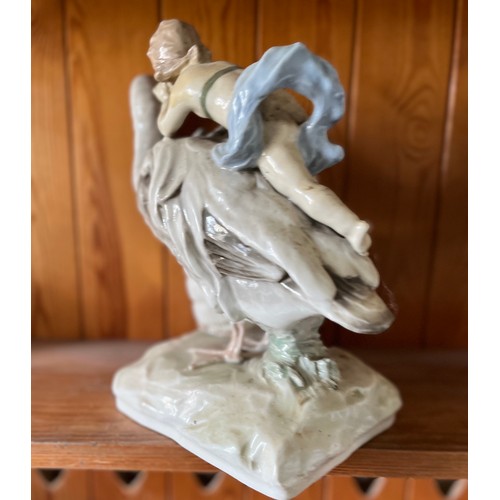 389 - Classical ceramic figure of a child on the back of a swan.

This lot is available for in-house shipp... 