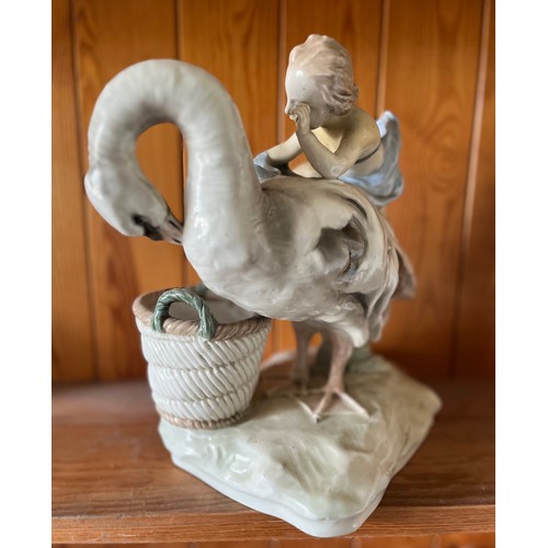 389 - Classical ceramic figure of a child on the back of a swan.

This lot is available for in-house shipp... 