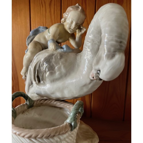 389 - Classical ceramic figure of a child on the back of a swan.

This lot is available for in-house shipp... 