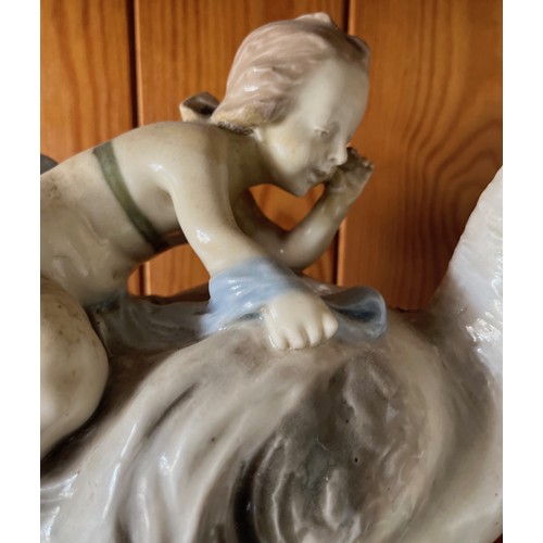 389 - Classical ceramic figure of a child on the back of a swan.

This lot is available for in-house shipp... 