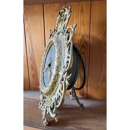 390 - An early C20th table clock with a cast brass surround.

This lot is available for in-house shipping