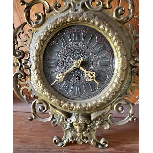 390 - An early C20th table clock with a cast brass surround.

This lot is available for in-house shipping