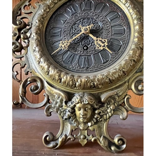 390 - An early C20th table clock with a cast brass surround.

This lot is available for in-house shipping