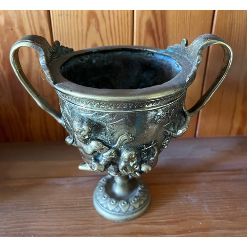 396 - A heavily cast brass twin handled vase decorated with classical figures.

This lot is available for ... 