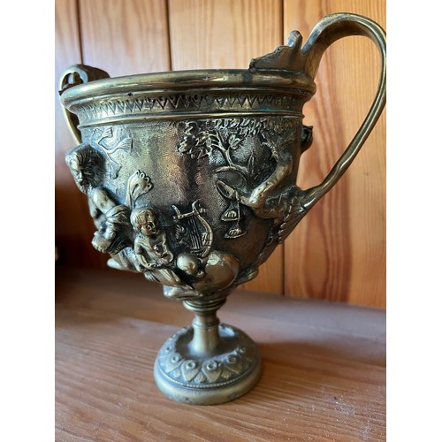 396 - A heavily cast brass twin handled vase decorated with classical figures.

This lot is available for ... 