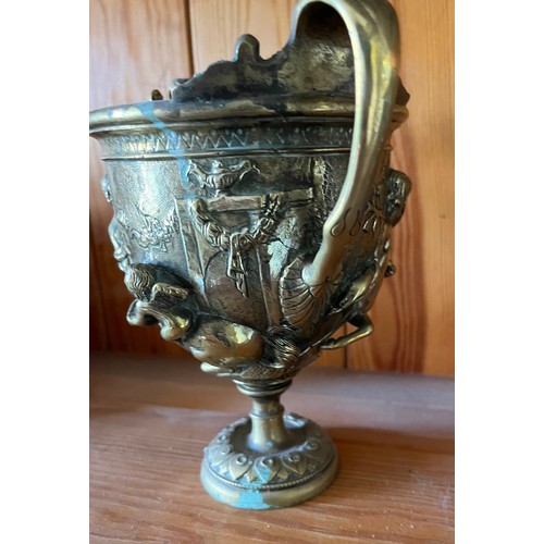 396 - A heavily cast brass twin handled vase decorated with classical figures.

This lot is available for ... 