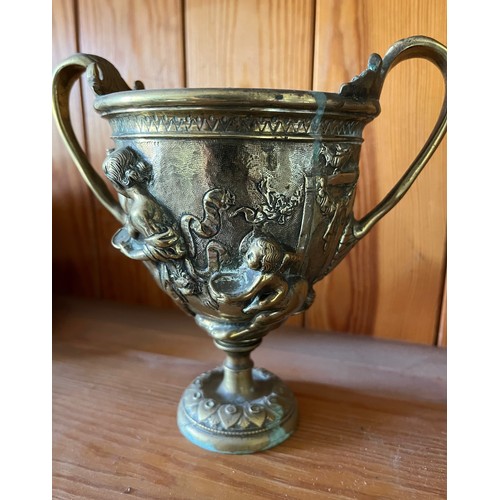 396 - A heavily cast brass twin handled vase decorated with classical figures.

This lot is available for ... 