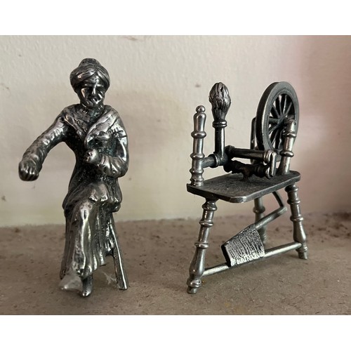 402 - Unmarked white metal cast figure of a woman and her spinning wheel.

This lot is available for in-ho... 