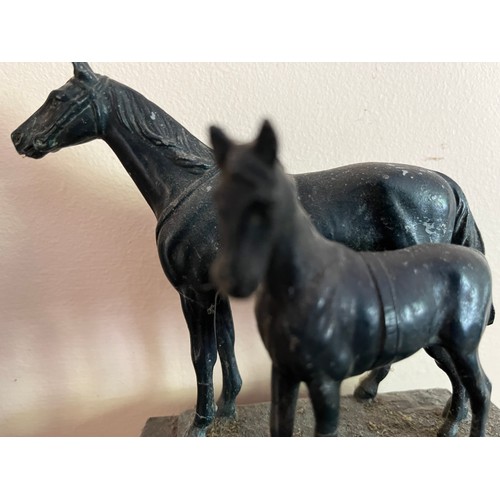 404 - Cast bronzed horse figures of a mother and foal on a marble base.

This lot is available for in-hous... 