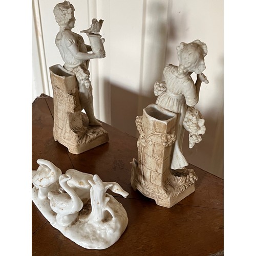 411 - A pair of classical Parian ware figures and a group of ducks.

This lot is available for in-house sh... 