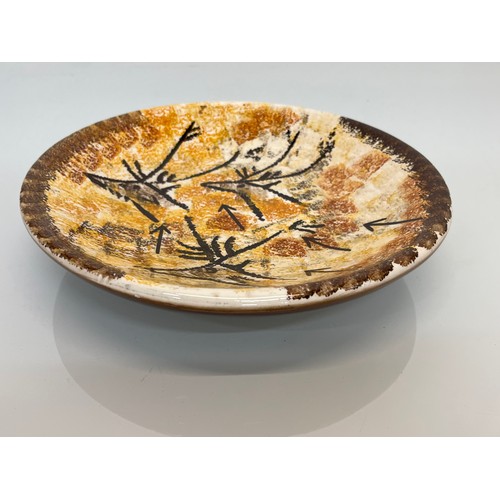 465 - Studio art pottery dish decorated with cave like drawings of deer, 26 cm x 5cm deep.

This lot is av... 