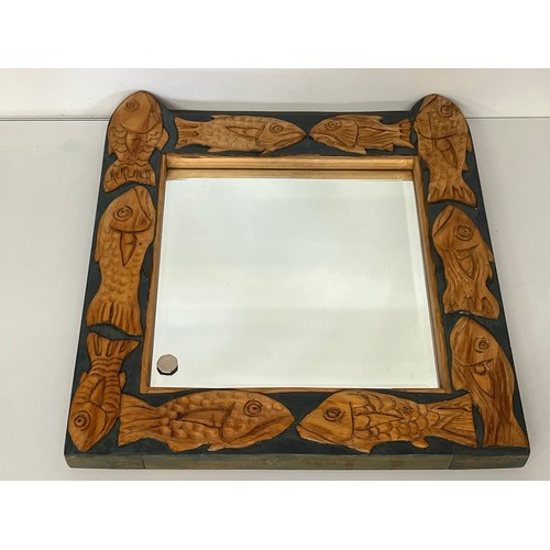 139 - Contempery hand carved wooden framed mirror, decorated with fish. 63 cm x 56 cm x 5 cm.

This lot is... 