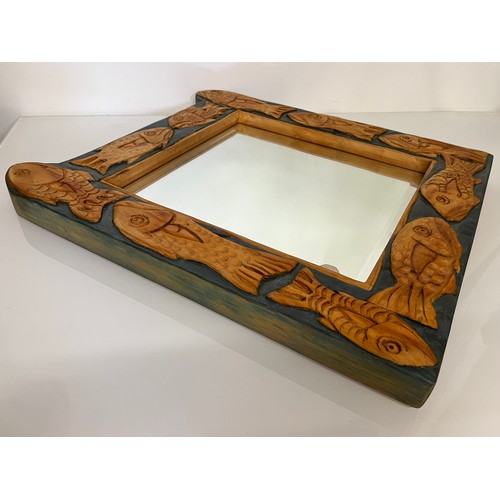 139 - Contempery hand carved wooden framed mirror, decorated with fish. 63 cm x 56 cm x 5 cm.

This lot is... 