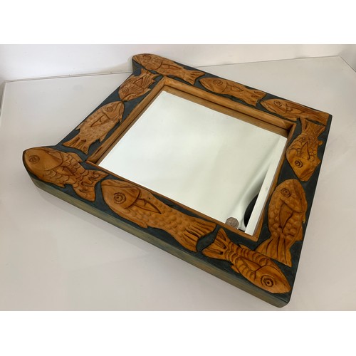 139 - Contempery hand carved wooden framed mirror, decorated with fish. 63 cm x 56 cm x 5 cm.

This lot is... 