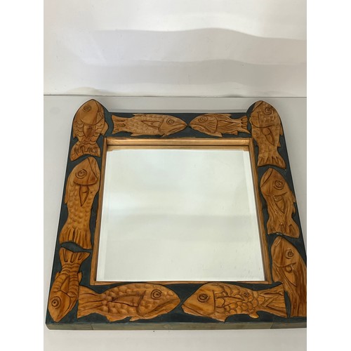 139 - Contempery hand carved wooden framed mirror, decorated with fish. 63 cm x 56 cm x 5 cm.

This lot is... 