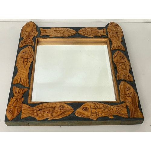 139 - Contempery hand carved wooden framed mirror, decorated with fish. 63 cm x 56 cm x 5 cm.

This lot is... 