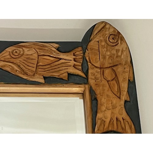 139 - Contempery hand carved wooden framed mirror, decorated with fish. 63 cm x 56 cm x 5 cm.

This lot is... 
