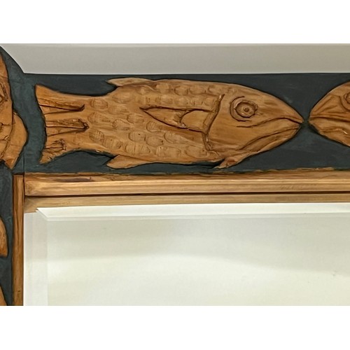 139 - Contempery hand carved wooden framed mirror, decorated with fish. 63 cm x 56 cm x 5 cm.

This lot is... 